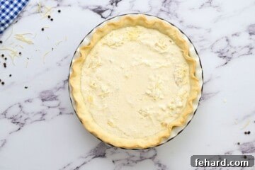 Bacon, cheese, and egg custard poured into prebaked pie crust.