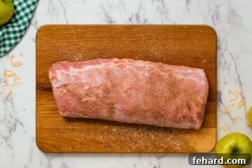 Hearty Slow Cooker Pork and Sauerkraut 3 Pork loin seasoned with salt and pepper on a cutting board, ready for searing.