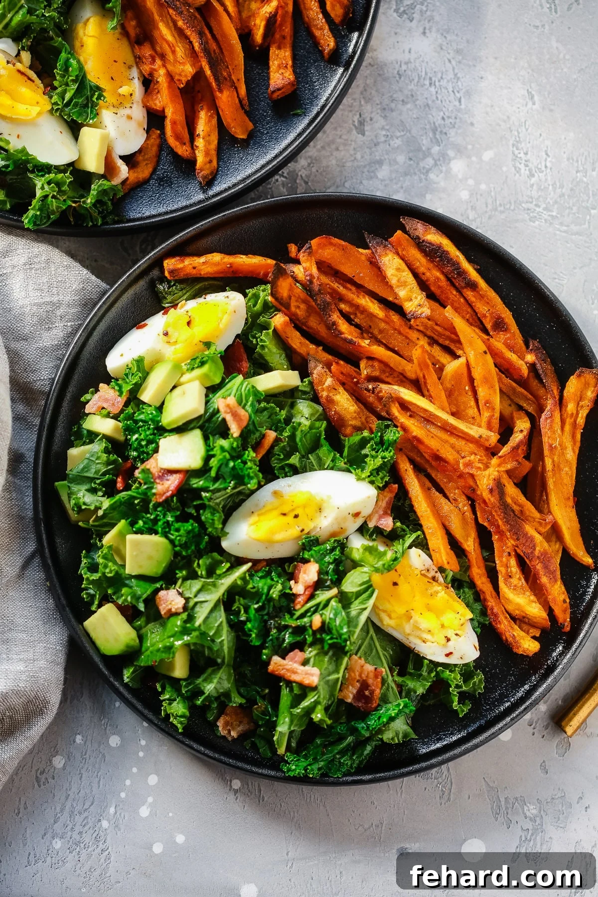 overhead view of a kale salad with sweet potato plate 