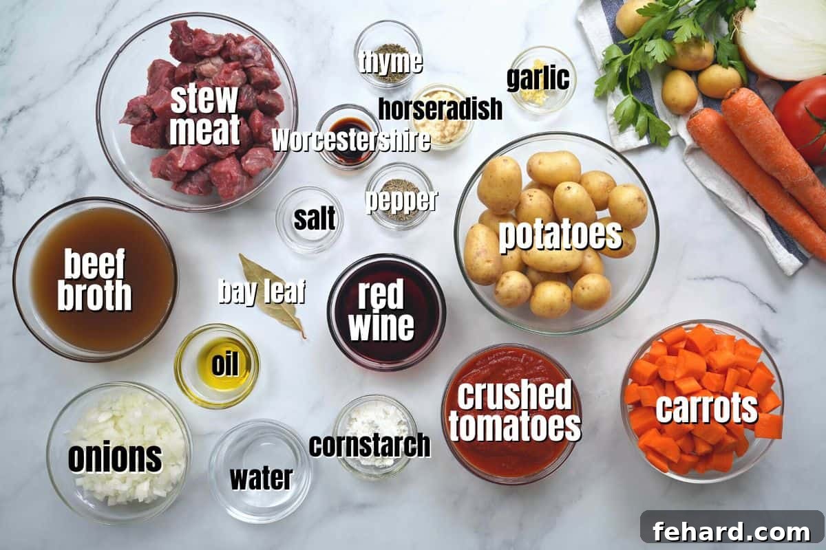 Assortment of fresh ingredients for beef stew laid out on a kitchen counter, including beef chunks, potatoes, carrots, onions, wine, and spices.