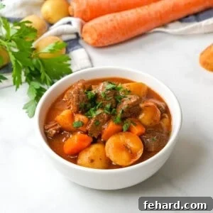 Bowl of instant pot beef stew topped with parsley.
