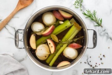 Effortless Turkey Brine for a Juicier Bird 4 Cooked Turkey brine in large stock pan with apples, onions, peppercorns, onions, and celery in stock pan.