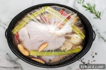 Effortless Turkey Brine for a Juicier Bird 6 Raw turkey in brine bag along with herbs and onions and brine bag tied tight.