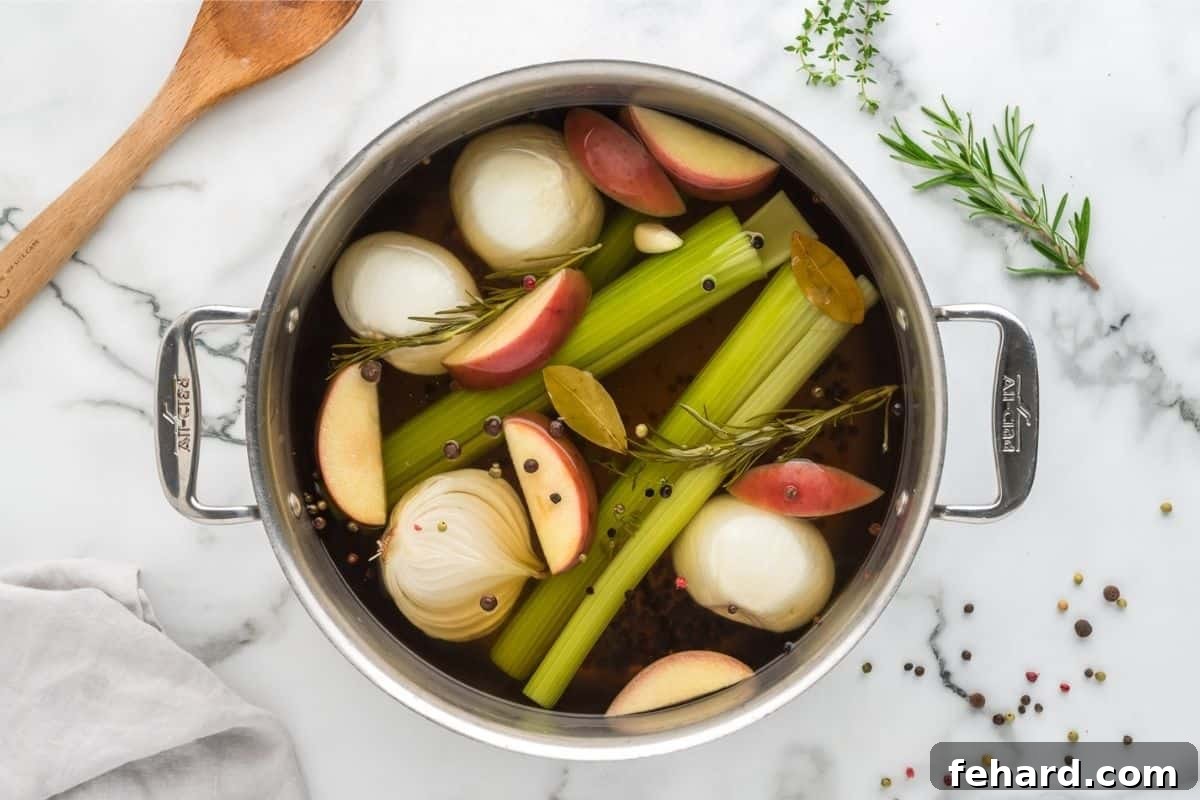 Easy Turkey Brine Cooked Turkey brine in large stock pan with apples, onions, peppercorns, onions, and celery in stock pan.
