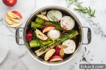 Effortless Turkey Brine for a Juicier Bird 3 Ingredients for Turkey brine in skillet with apples, onions, peppercorns, onions, and celery in stock pan.
