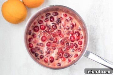 Saucepan with simmered cranberry sauce.