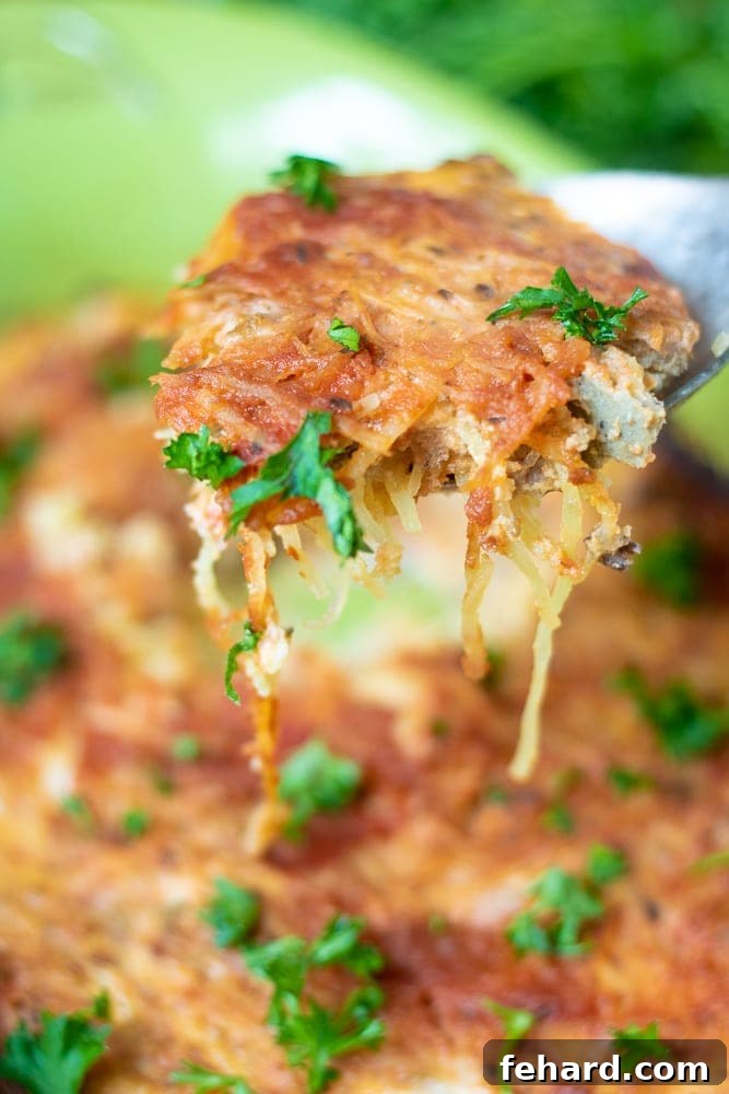 Spaghetti Squash Casserole: A Low-Carb Delight Easy Spaghetti Squash Casserole being dished out of casserole pan, showing golden-brown top and rich interior.