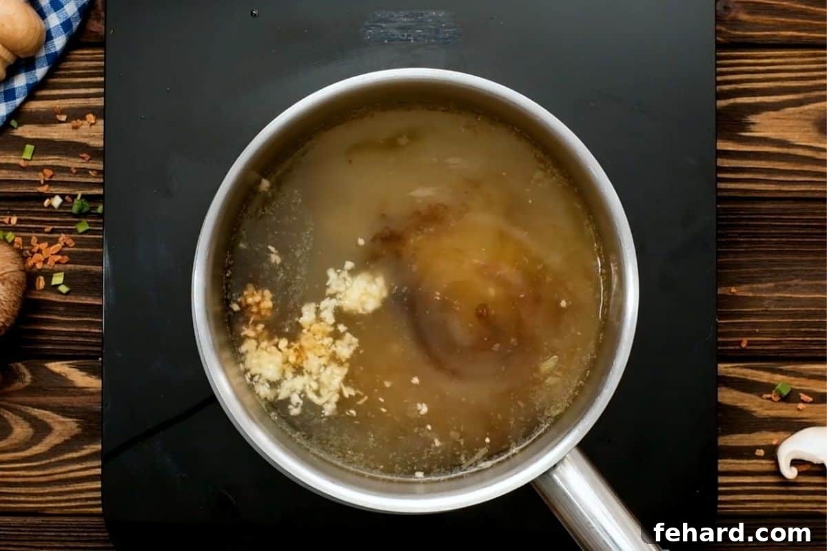 Easy Ramen Recipe Ingredients for Ramen Broth simmering gently in a saucepan, releasing their aromatic flavors.