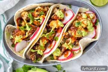 Roasted cauliflower on tortillas topped with avocado cream and radishes.
