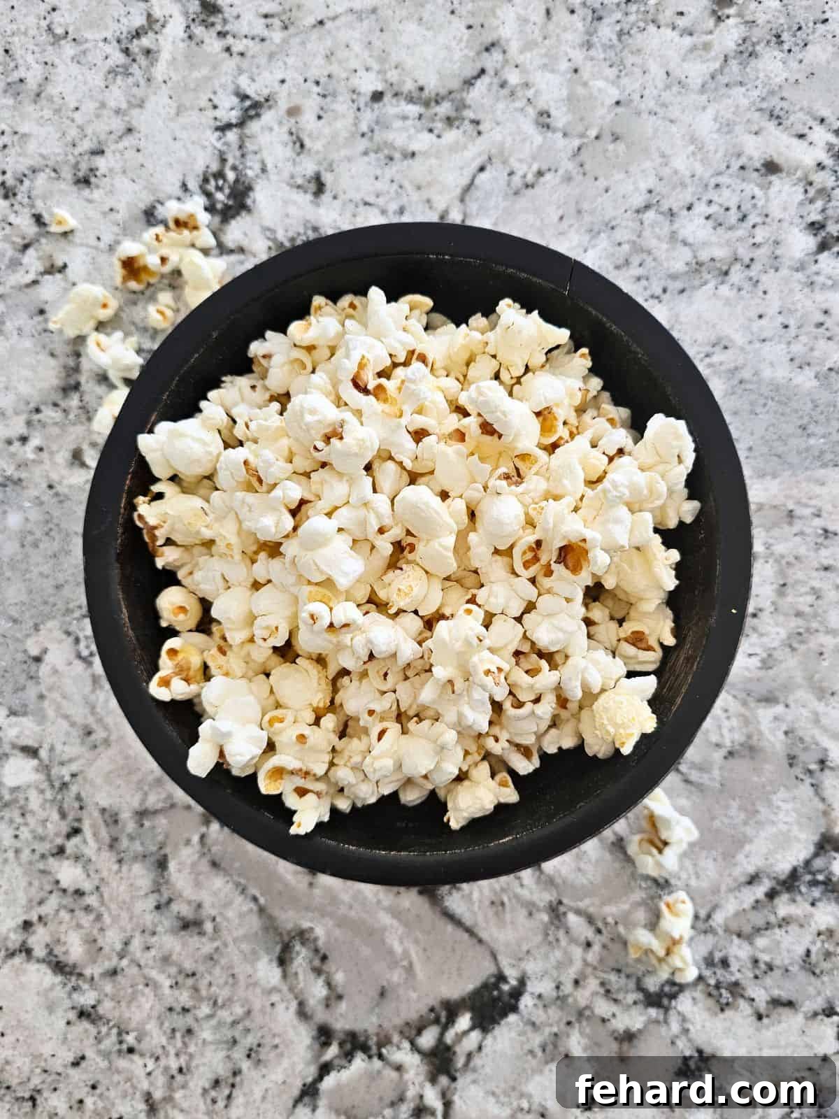 Homemade Microwave Popcorn in a black bowl, ready to be enjoyed.