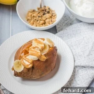 Baked Sweet Potato topped with slice banana and nut butter for a healthy breakfast.