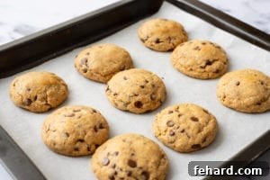 The Legendary Billion-Dollar Cookie Recipe 8 Baked Neiman Marcus Cookies on baking sheet.