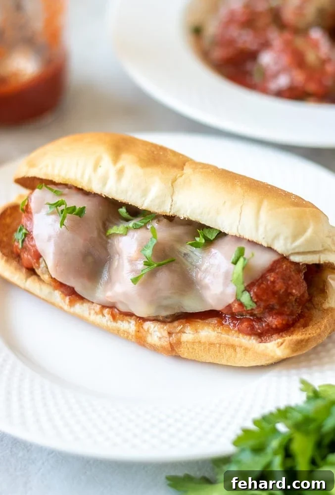 The Best Meatball Sub Recipe Meatball Sub on Hoagie Bun with Provolone Cheese, ready to be enjoyed.