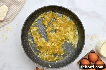 Green chiles and onions sauteed in melted butter in skillet.