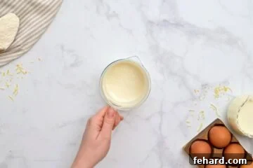milk, flour, and baking powder whisked together in a small glass measuring cup.