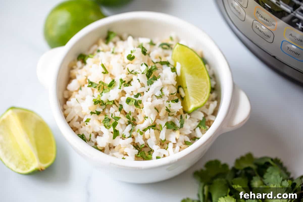 A vibrant bowl of Instant Pot cilantro lime rice, garnished with fresh lime wedges.