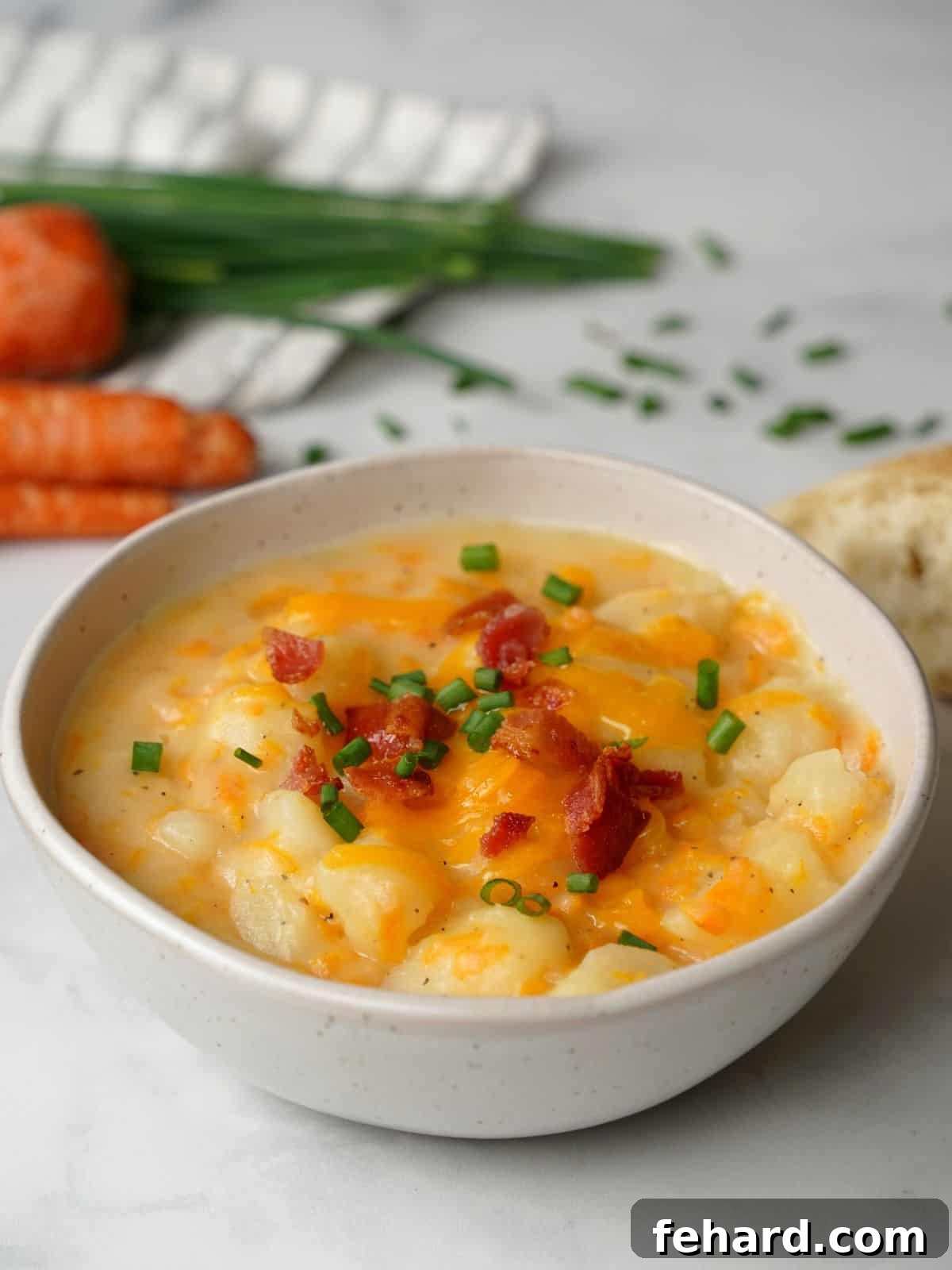 Instant Pot Baked Potato Soup Bowl of instant pot baked potato soup topped with cheese, bacon and chives.