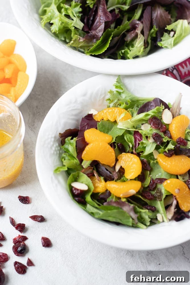 A fresh Mandarin Orange Salad featuring mixed greens, bright mandarin oranges, and crunchy almonds.