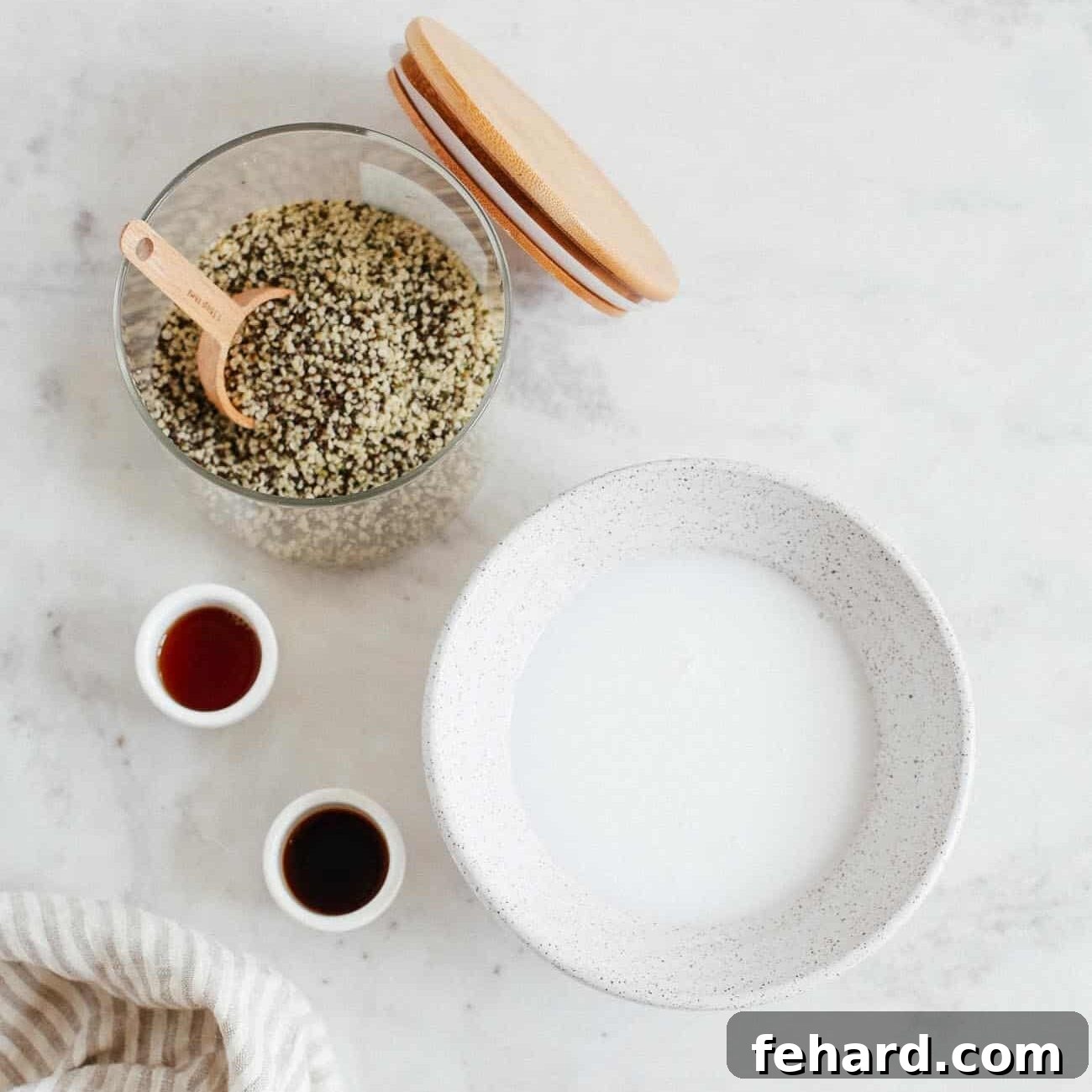 Dreamy Raspberry Chia Pudding 3 Chia seed pudding ingredients laid out, including chia seeds, coconut milk, maple syrup, vanilla extract, and salt.