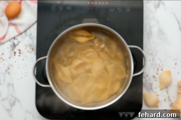Classic Italian Stuffed Shells 7 Jumbo shells boiling in large pot of boiling water, ensuring they are cooked perfectly.
