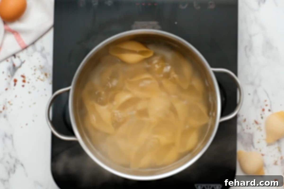 Easy Stuffed Shells Recipe Jumbo shells boiling in large pot of heavily salted water.