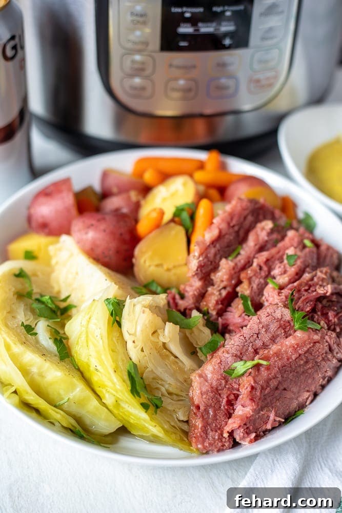 A beautifully plated Instant Pot Corned Beef, Cabbage, Potatoes, and Carrots ready to serve, next to an Instant Pot.