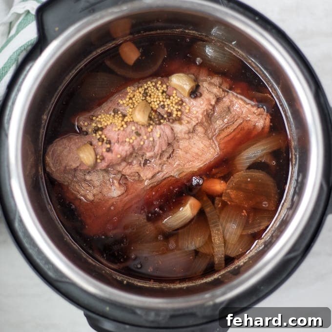 Perfectly cooked, tender corned beef brisket resting inside the Instant Pot after pressure cooking.