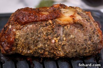 Roasted New York Strip Roast on broiler pan after being cooked to medium-rare.