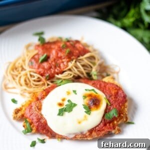 Chicken Parmesan served on white plate