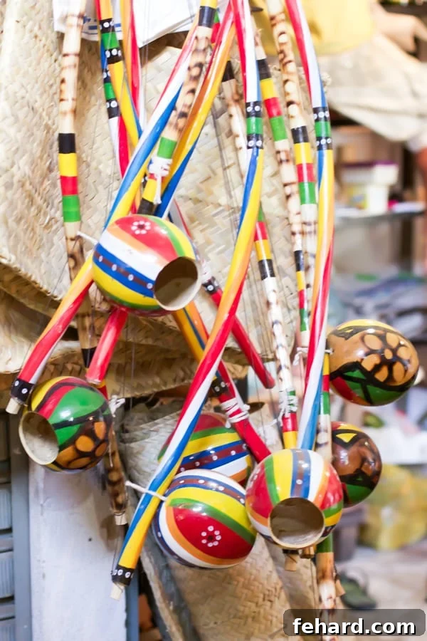 Colorful Birimbau percussion instruments hanging in a farmers' market stall in Brazil. 