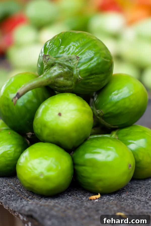 A closeup of several Jiló, which look like small green eggplants. 