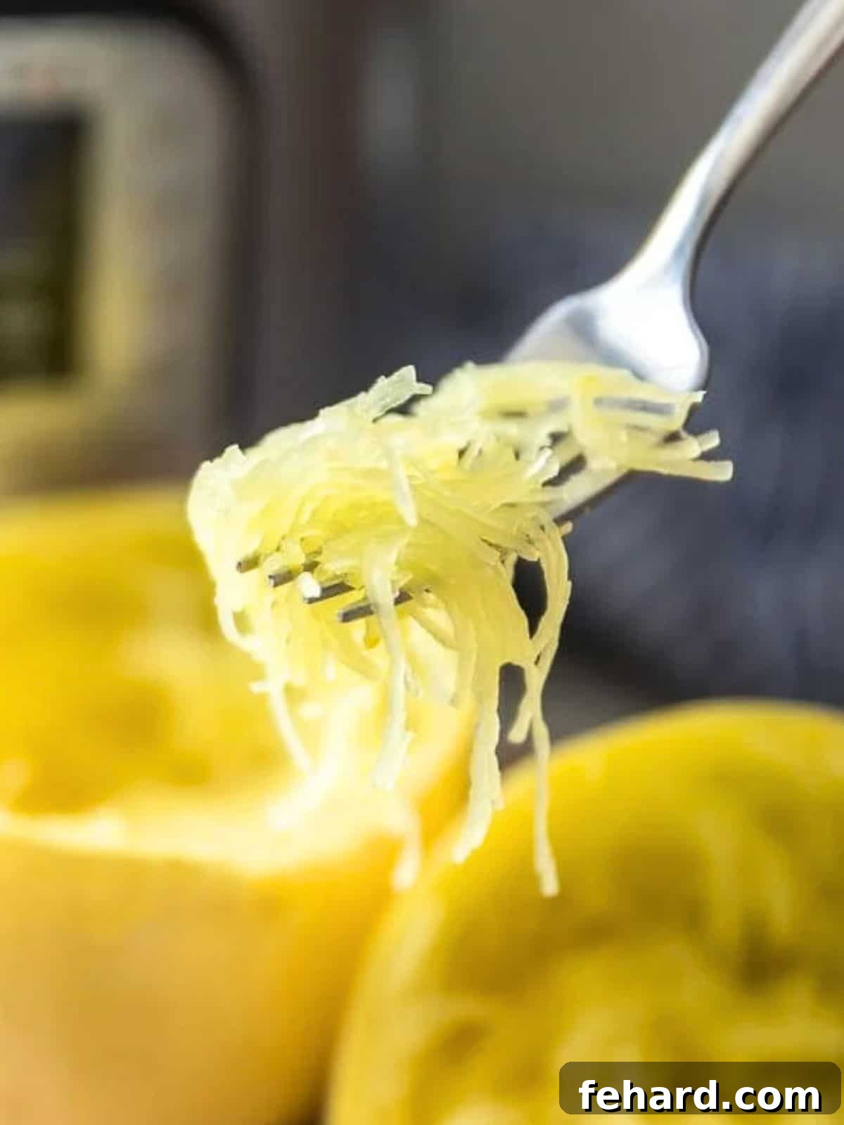 Instant Pot Spaghetti Squash Fork scooping out perfectly cooked spaghetti squash from squash next to Instant Pot.