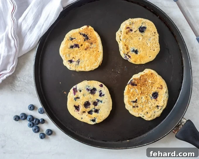 Egg Free Blueberry Pancakes on Griddle.