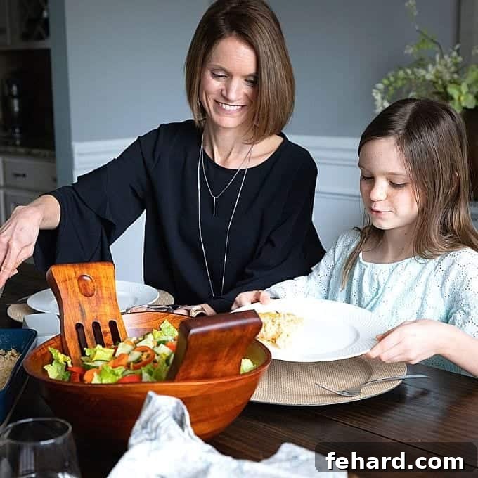 A warm, inviting family dinner scene with Layla and Kristen enjoying a wholesome meal at the table, symbolizing quality family time and delicious food.