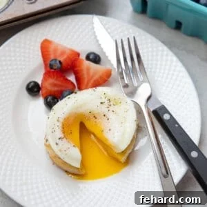 Oven Poached Egg on English muffin cut open with yolk running out onto plate.
