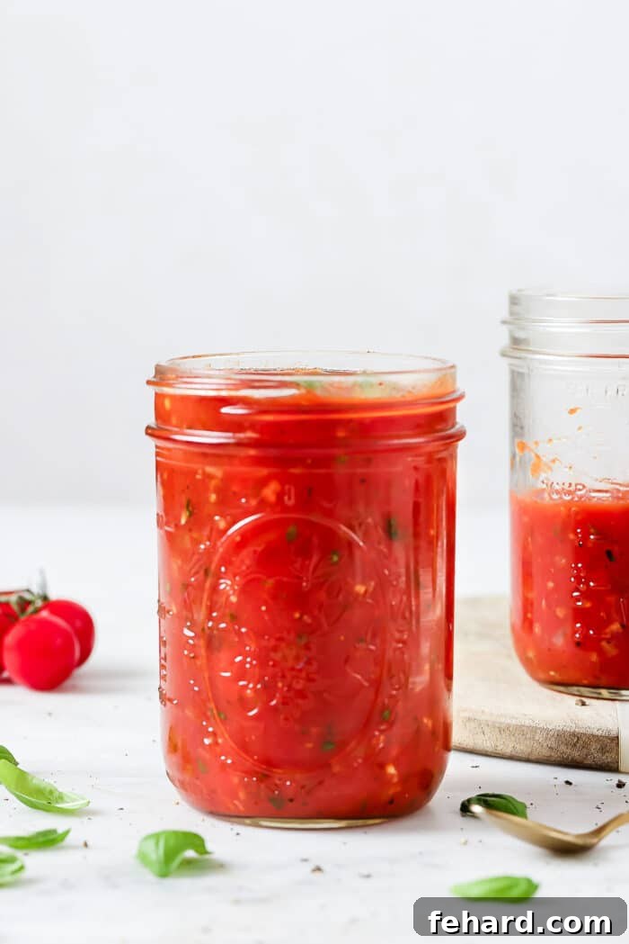 The Secret to Perfect Homemade Tomato Sauce 8 Cooling homemade tomato sauce being transferred into a mason jar for convenient storage.