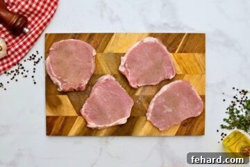 Thick-cut pork chops seasoned well with salt and pepper.