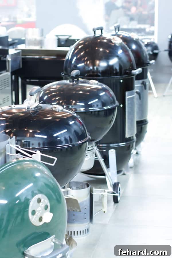 A pristine row of Weber grills, featuring one striking green and four classic black models of various sizes, perfectly aligned and ready for the grilling session.