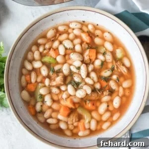 Bowl of Ham and Bean Instant Pot Soup in inner pot.