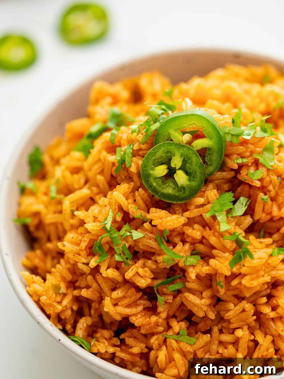 Instant Pot Spanish Rice Bowl of Instant Pot Mexican Rice topped with cilantro and fresh jalapenos, ready to serve.