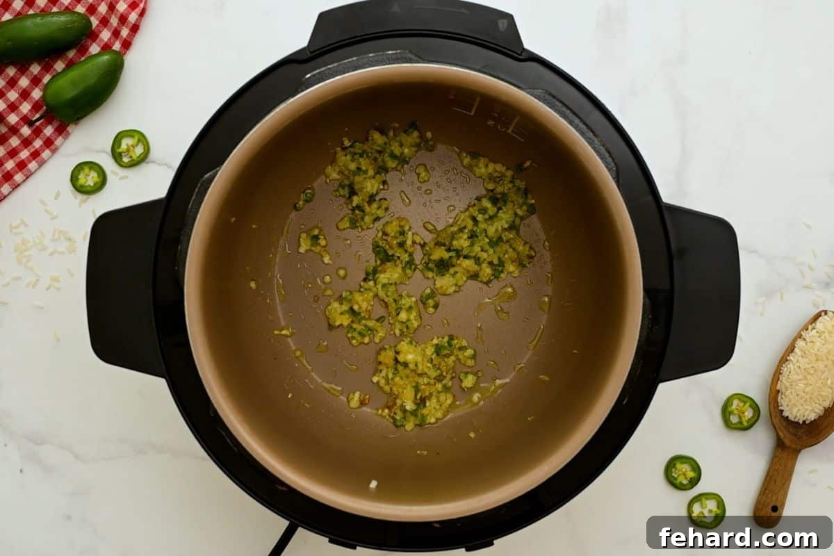 Spanish Rice Instant Pot Sauteed minced onion and jalapeno inside inner pot of Instant Pot.