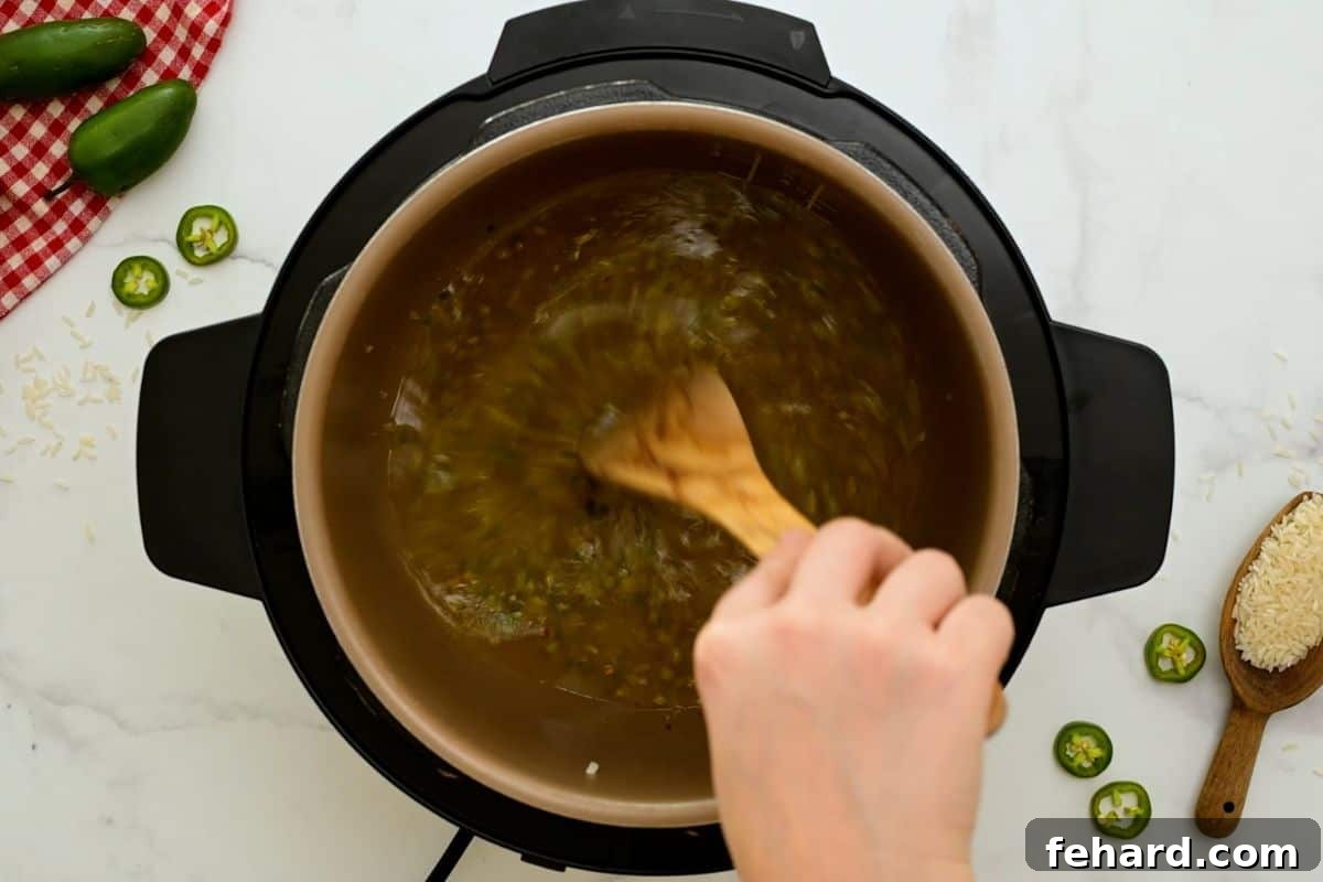 Instant Pot Mexican Rice Using a wooden spoon to scrape bottom of inner pot after adding chicken stock to prevent burn notice.