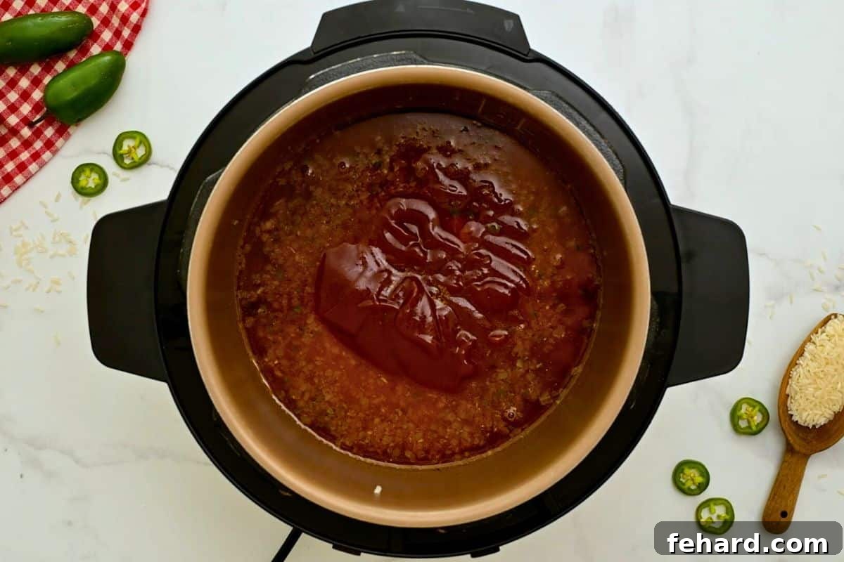 Mexican Rice Rice Instant Pot Liquid, rinsed rice, and tomato sauce carefully layered inside instant pot before pressure cooking.