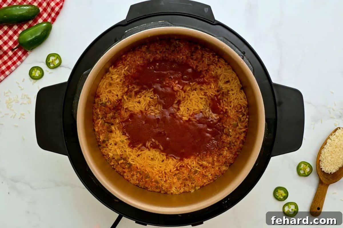 Easy Instant Pot Spanish Rice Recipe Cooked Spanish Rice inside inner pot before fluffing with a fork, after natural pressure release.
