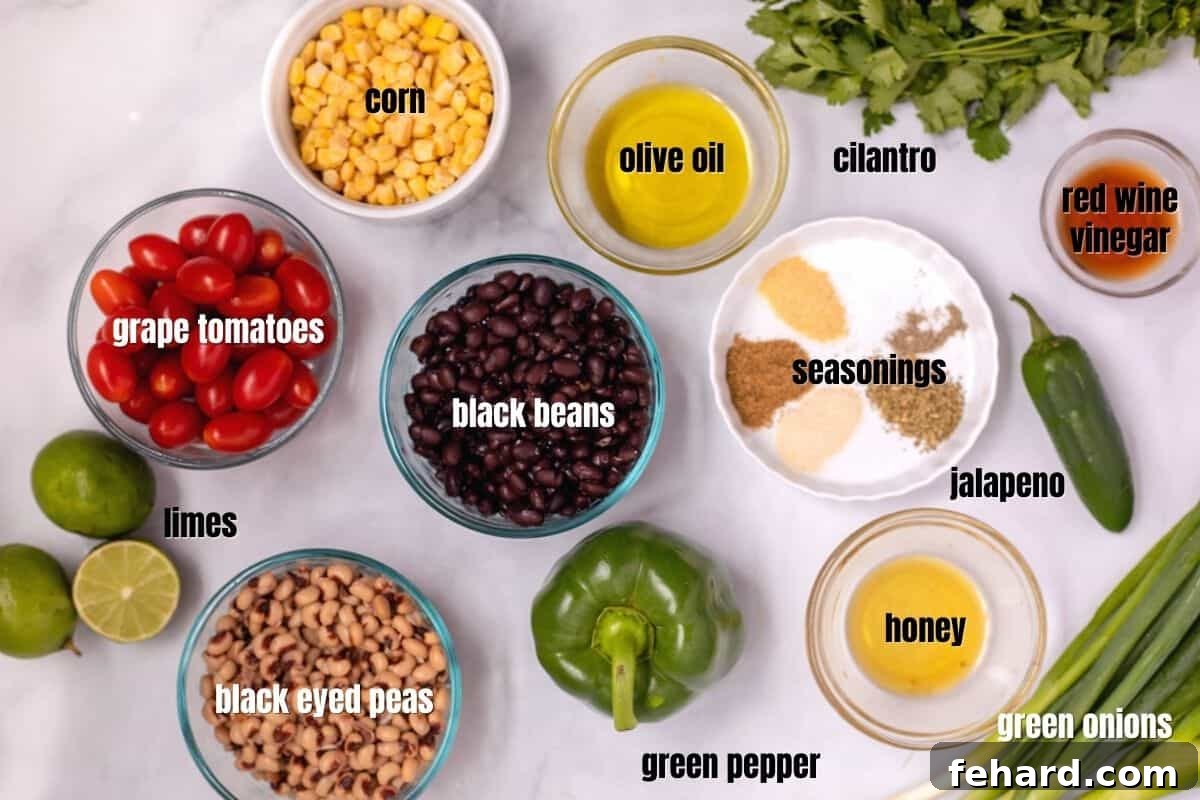 Cowboy Caviar Recipe Ingredients Labeled ingredients for Cowboy Caviar laid out on a clean white counter, including cans of beans and corn, fresh bell peppers, tomatoes, green onions, and cilantro, ready for preparation.