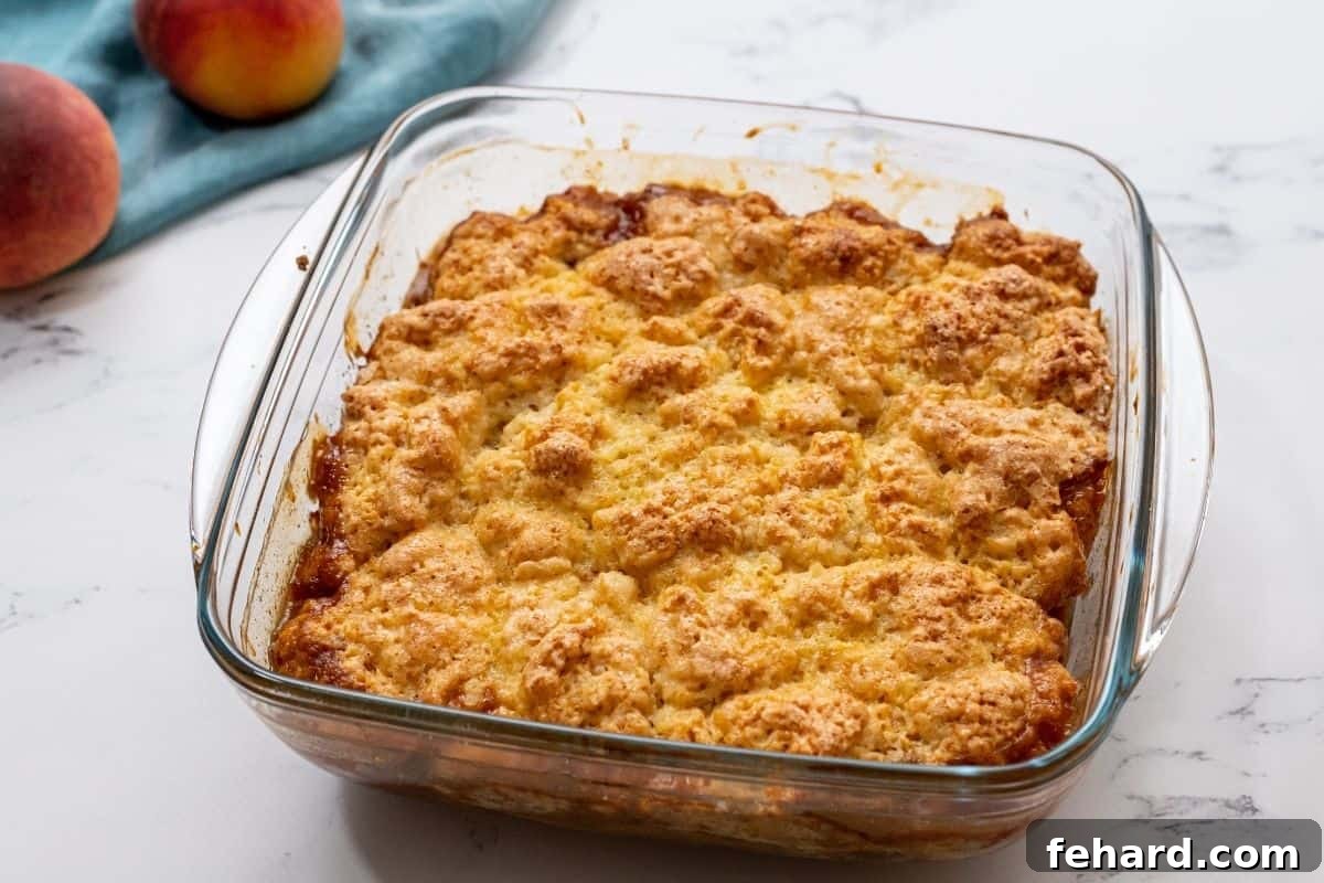 Baked Peach Cobbler in glass baking dish.