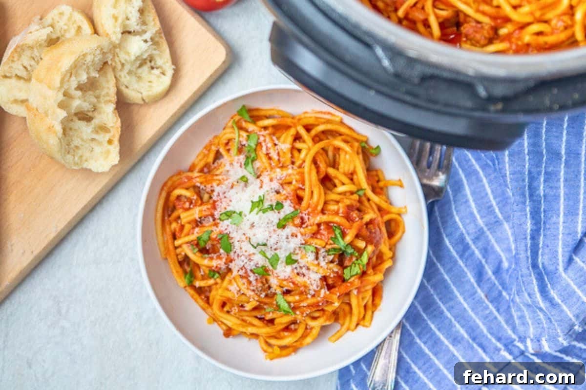 A beautiful white bowl filled with Instant Pot Spaghetti, elegantly garnished with fresh herbs and grated cheese, positioned beside the Instant Pot, eagerly awaiting enjoyment.