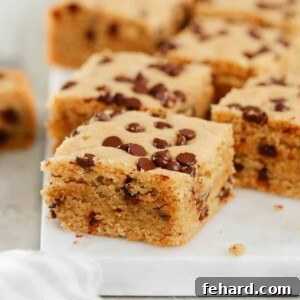 Close up of healthier chocolate chip cookie bars on a marble serving board.
