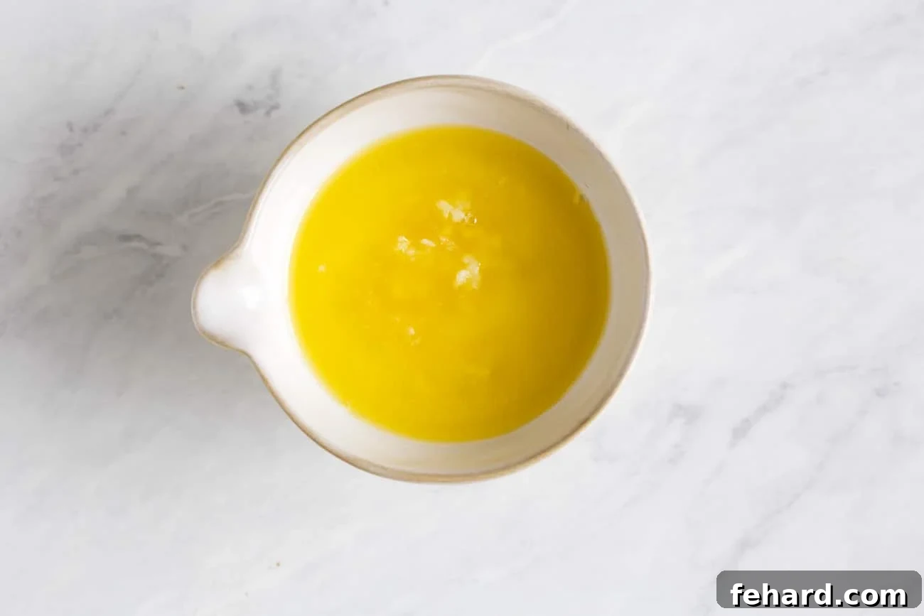 Overhead view of a small bowl containing the butter mixture, ready to be poured over the salmon.