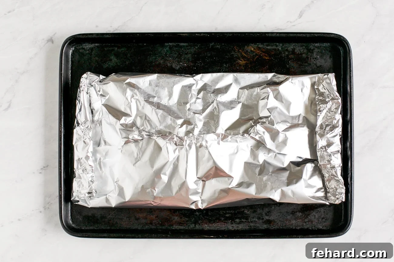Close-up view of the fish perfectly folded and sealed within the foil packet.